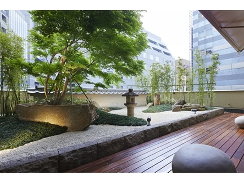 【石庭　ZEN TERRACE】
白砂に大小の石を配した枯山水を思わせる日本庭園に、ウッドデッキを調和させた和モダンな空間「石庭」。
日本の美意識が息づく景観を眺めながら、会議や会食のひとときを。