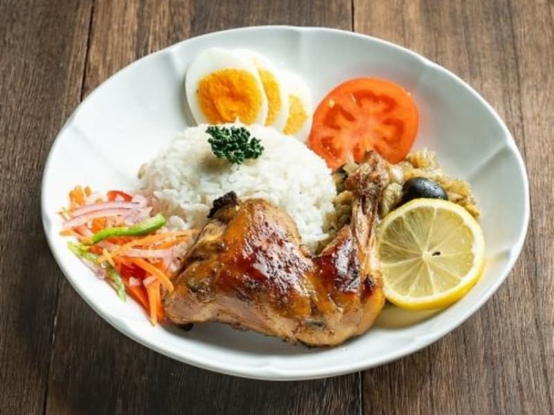丁寧に仕上げた本格アフリカンチキン料理。レモンを添えた彩り豊かなプレートで、素材の旨味を存分にお楽しみいただけます。