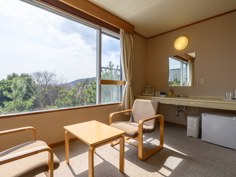 窓の向こうに広がるのは、木々の緑とやわらかな山の稜線。 何も足さず、何も引かず。 自然光がそっと包み込むこの眺めは、心の緊張をゆるめる静かな処方箋です。