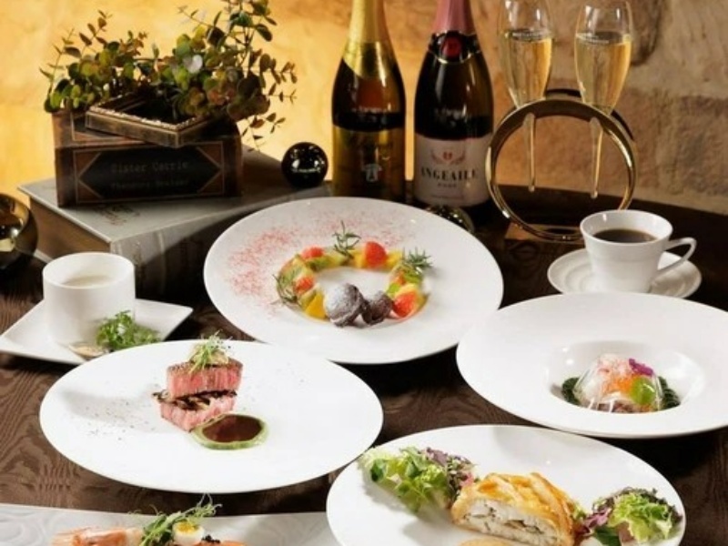 白いプレートに美しく盛り付けられた料理と、シャンパンやワインが並ぶ華やかなテーブル。記念日や会食にふさわしい贅沢なひとときです。