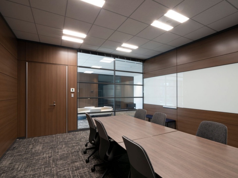 壁面の一部が大型のホワイトボードになっており、います。ガラスパーテーション越しに外の通路が見える、適度な開放感のある構造です。